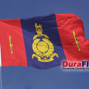 May include: A flag waving in the wind against a blue sky. The flag has a central blue panel with a gold emblem and text, flanked by red panels with gold dagger symbols. The text "DuraFlag" is visible.