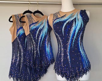 May include: Navy blue leotards with blue and light blue feather-like designs and sparkling embellishments. The leotards are displayed on a mannequin and hangers. The neckline and upper back are nude-colored mesh.