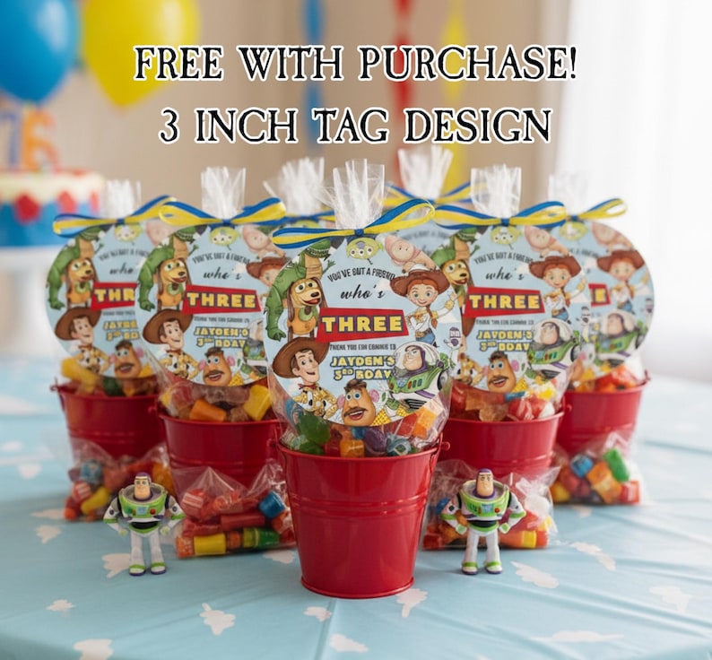 May include: Several red buckets filled with candy and Toy Story-themed party favors. Each favor bag has a circular tag with the text "THREE" and character illustrations. The image includes the text "FREE WITH PURCHASE! 3 INCH TAG DESIGN".