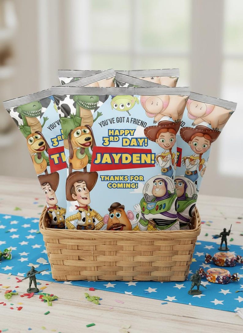 May include: A woven basket filled with several snack bags featuring characters from the Toy Story movie. The bags have the text "YOU'VE GOT A FRIEND HAPPY 3RD DAY! JAYDEN! THANKS FOR COMING!" on them. Small toy soldiers and candies are scattered around the basket.