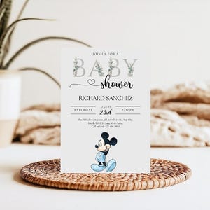 May include: A baby shower invitation featuring the text "BABY shower" with floral accents. The invitation includes the name "RICHARD SANCHEZ", date, time, and a cartoon image of Mickey Mouse in blue. The invitation is on a white background.