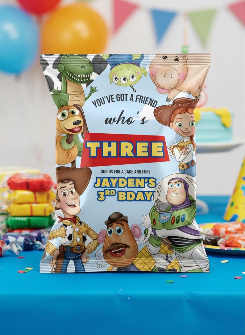 May include: A colorful party favor bag featuring characters from the Toy Story movie. The bag has the text "YOU'VE GOT A FRIEND who's THREE" and "JAYDEN'S 3RD BDAY". The bag is decorated with images of Woody, Buzz Lightyear, and other characters.