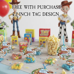May include: A festive party scene with Toy Story-themed decorations. Includes popcorn, candy, and tags that read "You've Got a Friend in Me" and "THREE". The text "FREE WITH PURCHASE! 3 INCH TAG DESIGN" is also visible.