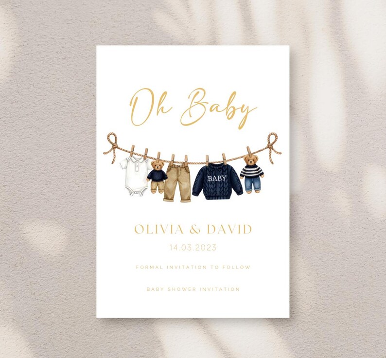 May include: Baby shower invitation with the words "Oh Baby" in gold script. The invitation features illustrations of baby clothes and teddy bears hanging on a clothesline. The names Olivia & David and the date 14.03.2023 are also included.