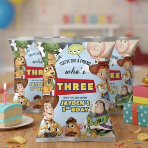 May include: Birthday-themed chip bags featuring Toy Story characters. The bags have the text "You've Got a Friend Who's Three" and "Jayden's 3rd Bday". The background includes balloons, a cake, and presents.