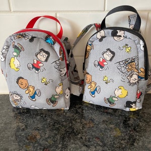 charlie brown mini backpack Peanuts Mystery Keychain Charm (ONE RANDOM CHARM) charlie collection Rains Mini W3 Backpack Colour:Desert Sand inches deep