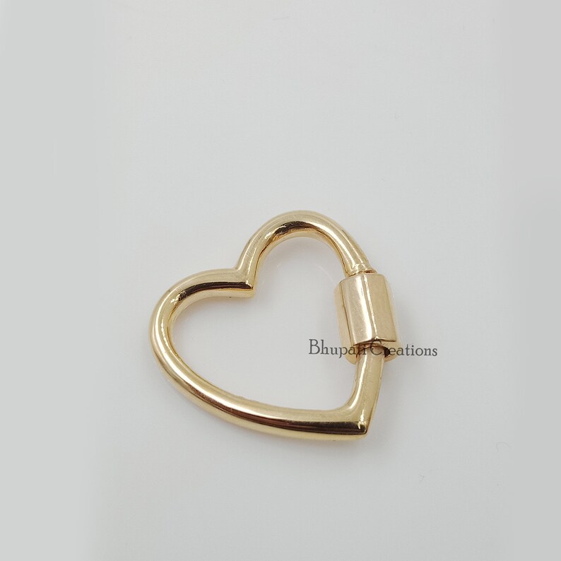 May include: Gold heart-shaped swivel clasp. This clasp is perfect for adding a touch of elegance to your jewelry or crafts.