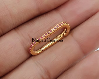 May include: Gold-toned clasp with a row of small red gemstones around the perimeter. The clasp is marked "925" and "Bhimpati Creations".
