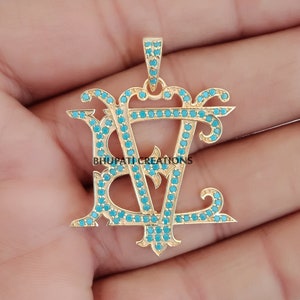 May include: Gold pendant with the letters "BV" in a decorative script, set with turquoise blue stones.