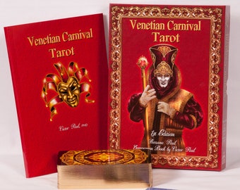 May include: A red box set and book titled "Venetian Carnival Tarot" with gold lettering and a gold mask illustration. The set includes a deck of cards and a companion book. The cards are displayed with several face-up.