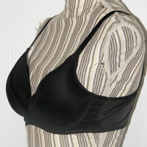May include: A black underwire bra with adjustable straps. The bra has a smooth, seamless design and is made of a soft, comfortable fabric.