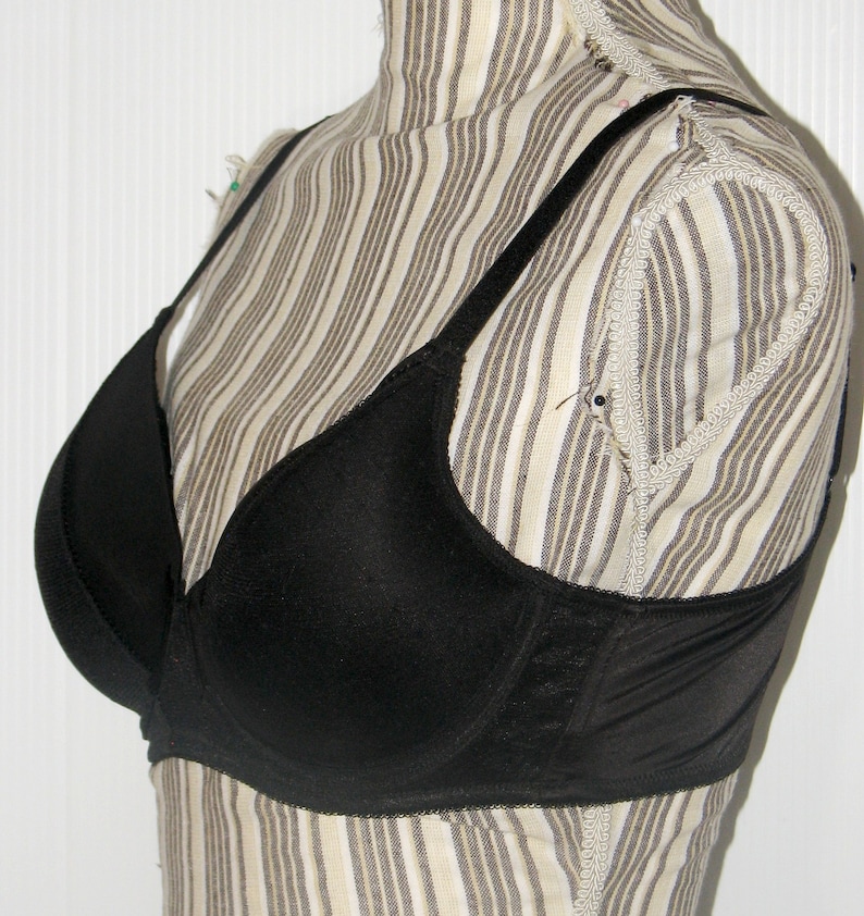 May include: A black underwire bra with adjustable straps. The bra has a smooth, seamless design and is made of a soft, comfortable fabric.
