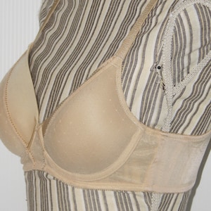 May include: A beige underwire bra with adjustable straps and a smooth, seamless cup.