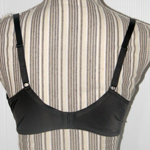 May include: Black bra with adjustable straps and a hook and eye closure in the back.