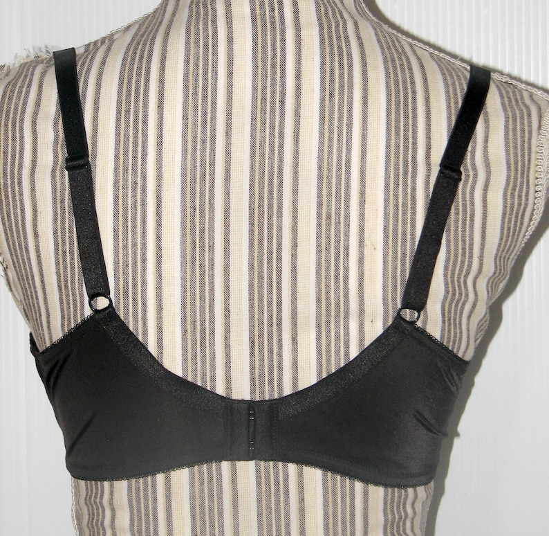 May include: Black bra with adjustable straps and a hook and eye closure in the back.