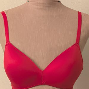 May include: A bright pink seamless bra with adjustable straps.