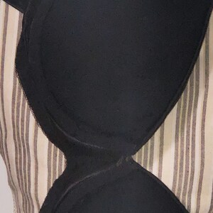 May include: Black undergarment with a smooth, seamless design. The undergarment is made of a soft, stretchy fabric and has a comfortable fit.