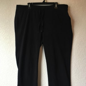 May include: Black drawstring pants with a relaxed fit.