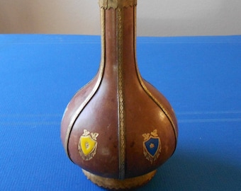 Vintage Italian wine decanter/whiskey bottle/leather wrapped & textured/brown with six court of arms in different colors