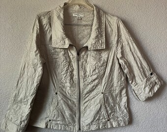 May include: A white quilted jacket with a zipper closure and a collar. The jacket has a brand label that reads "Coldwater Creek".