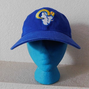 May include: A blue baseball cap with a yellow and white embroidered Los Angeles Rams logo.