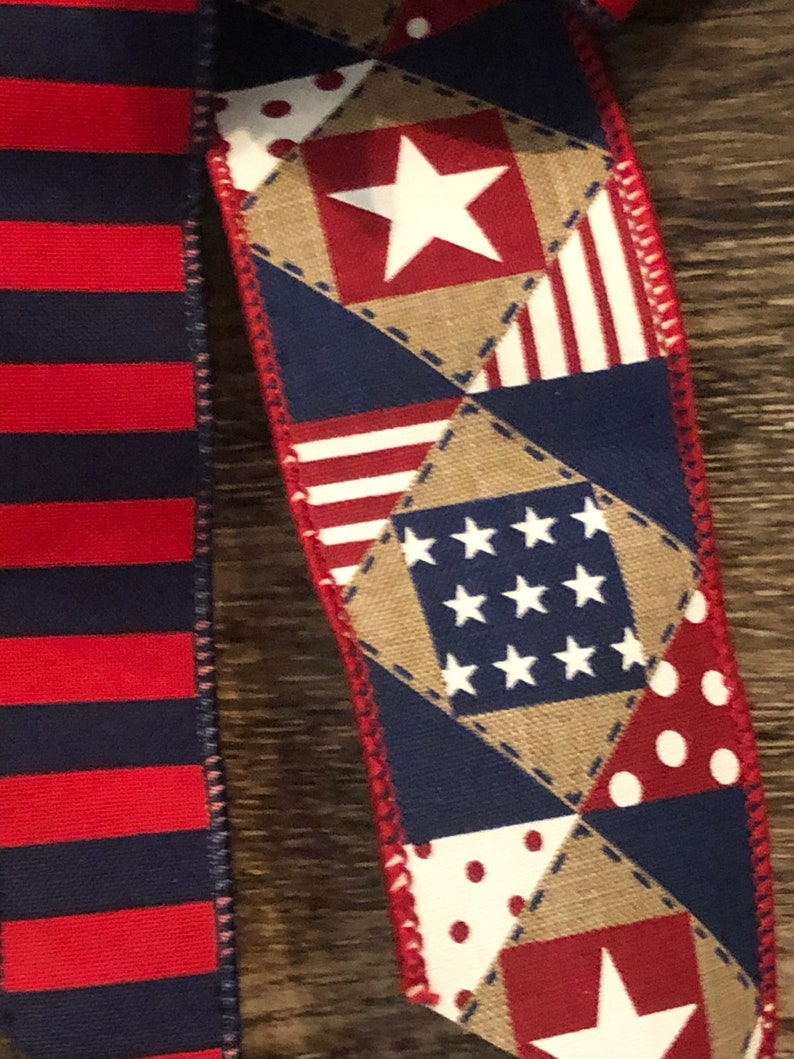 May include: Red, white, and blue patterned ribbon with stars and stripes. The ribbon is made of a patchwork of different fabrics.