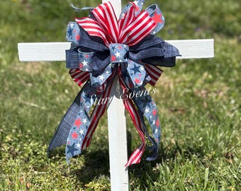 Memorial day crosses with bows. Memorial day grave decorations. Wooden cross