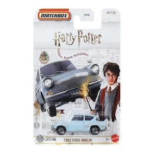 May include: Matchbox Harry Potter 1962 Ford Anglia die-cast car. The packaging features a light blue car, a flying gray car, and an image of Harry Potter. The packaging also includes the text "forbidden forest".