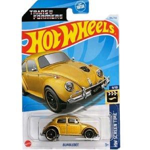 May include: A yellow Bumblebee Hot Wheels die-cast car in its original packaging. The packaging features the Transformers logo, the Hot Wheels logo, and the text "HW Screen Time". The car is a replica of a classic car.