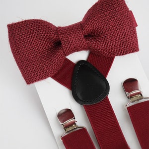 May include: A burgundy bow tie made of burlap fabric and matching burgundy braces with silver clips and a black leather adjustable strap.