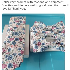 May include: A set of two bow ties and a necktie with a floral pattern in shades of blue, pink, and white on a white background.