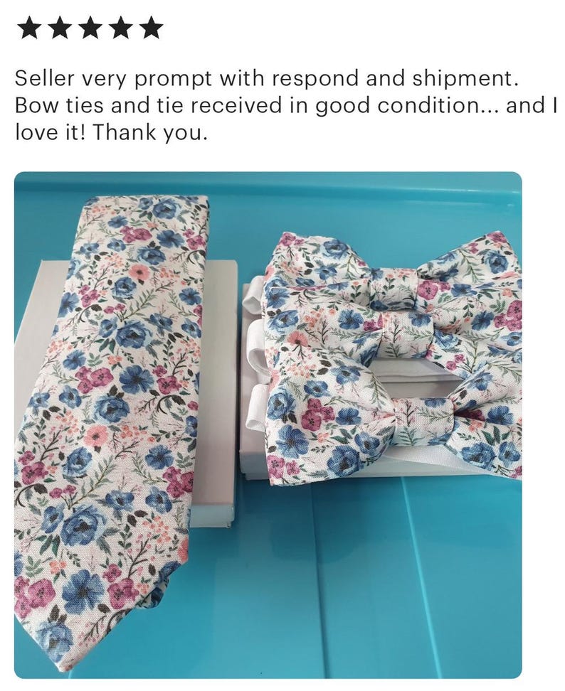 May include: A set of two bow ties and a necktie with a floral pattern in shades of blue, pink, and white on a white background.