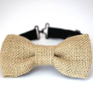 May include: A brown burlap bow tie with a black adjustable strap.