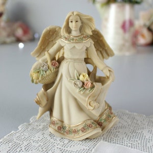 Figura de Sarah's Angels®, ángel con cesta de flores, resina verde marfil