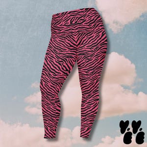 May include: High-waisted leggings featuring a vibrant hot pink and black zebra stripe pattern. The leggings have a fitted silhouette that extends to the ankles, showcasing a bold animal print design throughout the entire garment fabric.