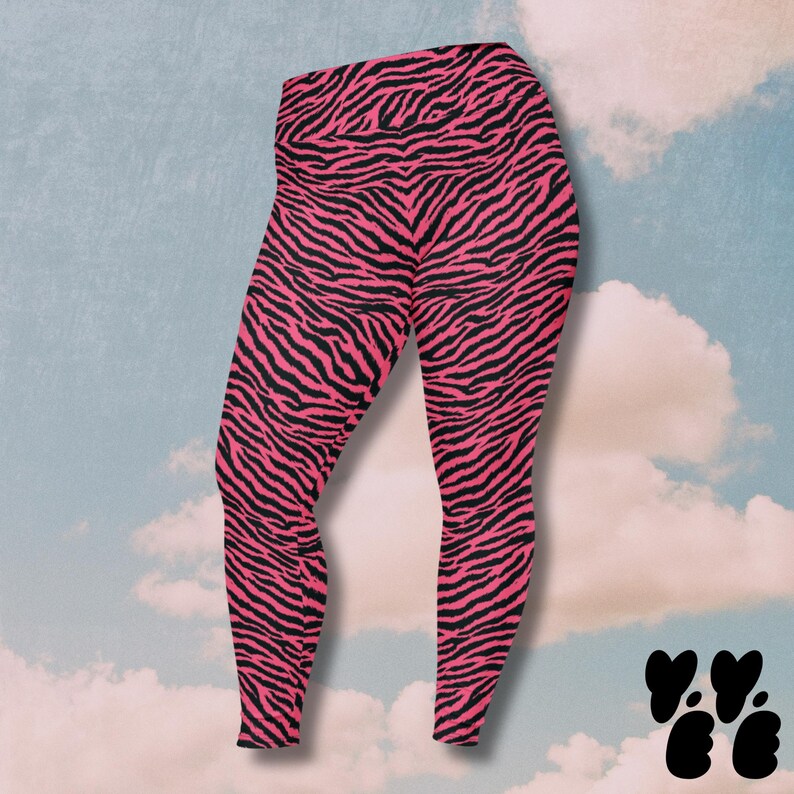 May include: High-waisted leggings featuring a vibrant hot pink and black zebra stripe pattern. The leggings have a fitted silhouette that extends to the ankles, showcasing a bold animal print design throughout the entire garment fabric.