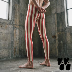 May include: Full-length leggings featuring a vertical striped pattern in alternating red and off-white colors. The leggings are form-fitting, extending from the waist down to the ankles, with a consistent striped design throughout the entire garment.