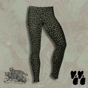 May include: Full-length leggings featuring an olive green base color with a repeating black leopard print pattern. The garment has a high-waisted design and a fitted silhouette that extends down to the ankles, showcasing a consistent animal print.