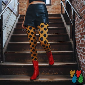May include: Mustard yellow leggings featuring a large black polka dot pattern, paired with black leather-look shorts and bright red ankle boots. The text Studio YéYé is visible on the leggings, and a colourful heart-shaped logo is in the corner.