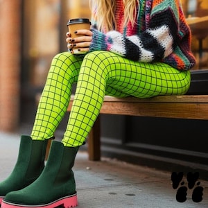 May include: Bright neon green leggings featuring a black grid pattern, paired with dark forest green ankle boots that have a thick pink sole. The outfit includes a multi-colored chunky knit sweater with horizontal stripes in shades of red, blue, and white.
