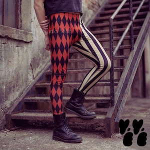 May include: Leggings featuring a split design with a red and black diamond harlequin pattern on one leg and vertical black and cream stripes on the other. The leggings are paired with black lace-up leather boots and a black t-shirt.