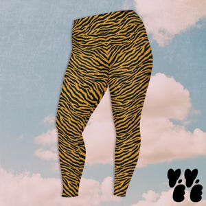 May include: High-waisted leggings featuring a vibrant tiger stripe pattern in shades of black and orange. The garment has a fitted silhouette that extends to the ankles, showcasing a continuous animal print design across the entire fabric surface.