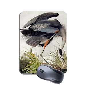 May include: A vintage illustration of a great blue heron standing in tall grass. The bird is depicted in shades of grey and blue with a red-orange breast and a long, pointed beak. The illustration is set against a light grey background.