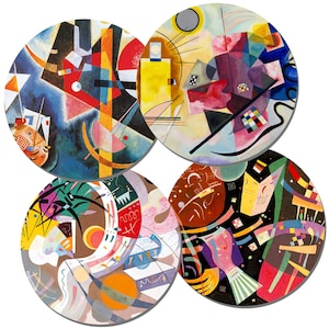 May include: Four round coasters featuring abstract geometric designs in bright colors, including red, yellow, blue, green, black, and white.
