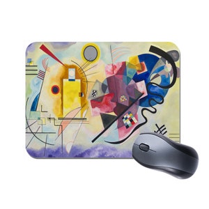 May include: Abstract art mouse mat featuring a colourful geometric design with yellow, red, blue, and black shapes on a white background.