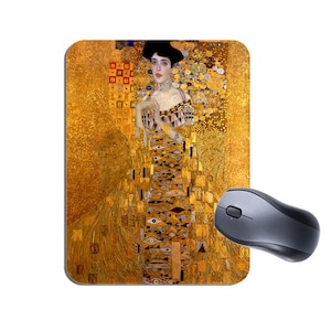 May include: A gold mouse pad with a painting of a woman in a gold dress. The woman has long dark hair and is wearing a gold necklace. The background is a gold mosaic pattern.
