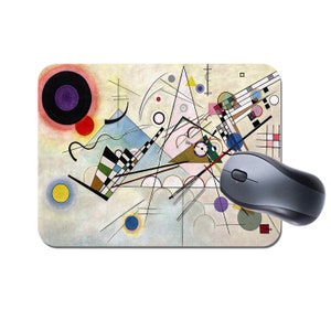 May include: Abstract art mouse mat featuring a colourful geometric design with circles, squares, and lines on a white background.