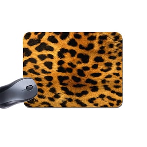 May include: A brown and black leopard print mouse mat. The mat has a soft, fuzzy texture.