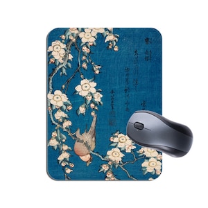 May include: A blue and white Japanese woodblock print of a bird perched on a branch of a flowering cherry tree. The print is surrounded by Japanese text.