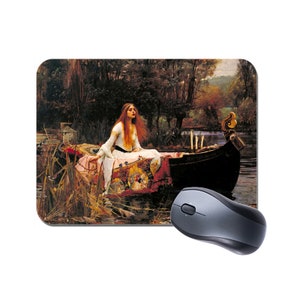 May include: A woman in a white dress sits in a boat on a lake. She has long red hair and is looking down. The boat is decorated with a red and gold tapestry. The background is a lush green forest.